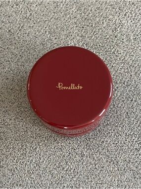 Pomellato deep red round jewelry case with gold logo